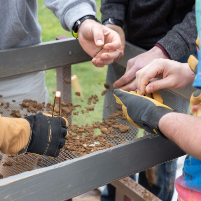 Students sifting and sorting through rubble
