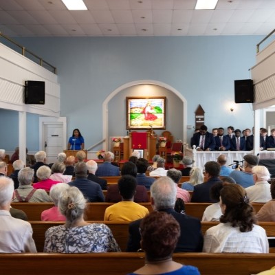 a crowd gathered for a lecture event in a church sanctuary