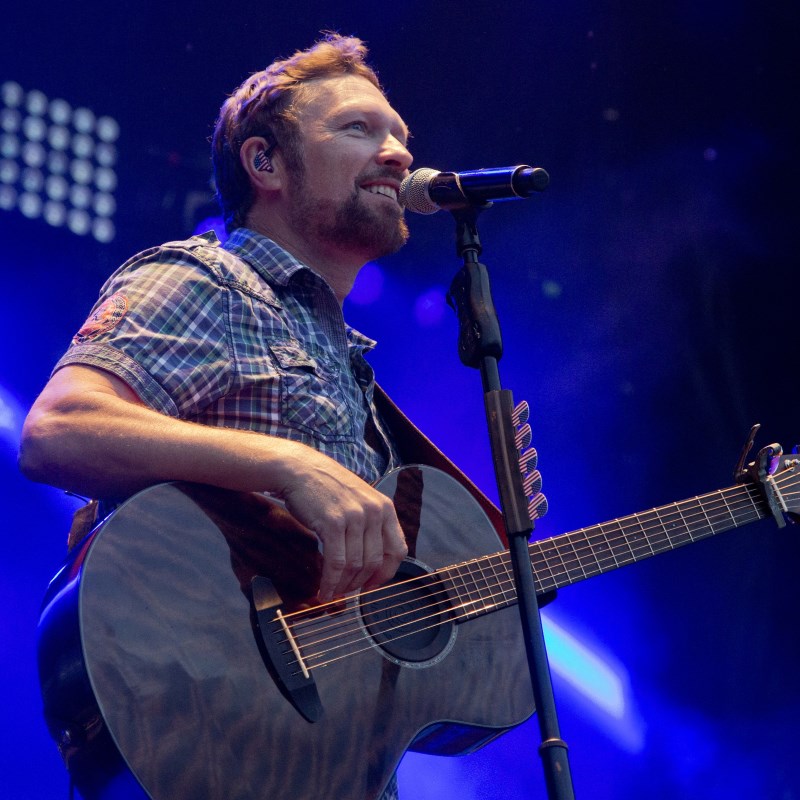 Craig Morgan playing guitar in blue lights