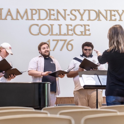 Hampden-Sydney Chorus members singing under direction of their professor